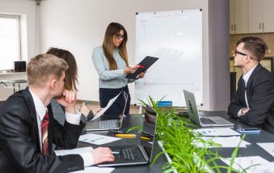 young-businesswoman-looking-document-board-meeting_23-2147838531